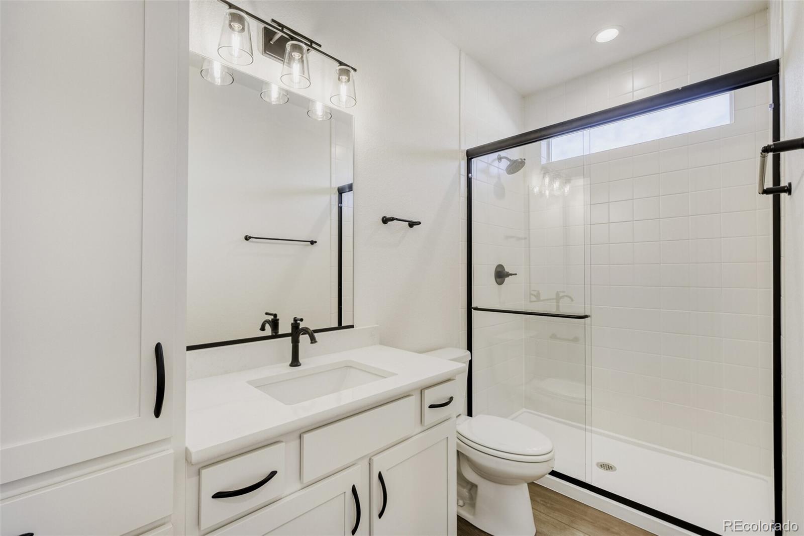 9659 Owl Perch Loop Colorado Springs, CO 80908 - Photo 21 of 28 a bathroom with a sink a toilet and shower