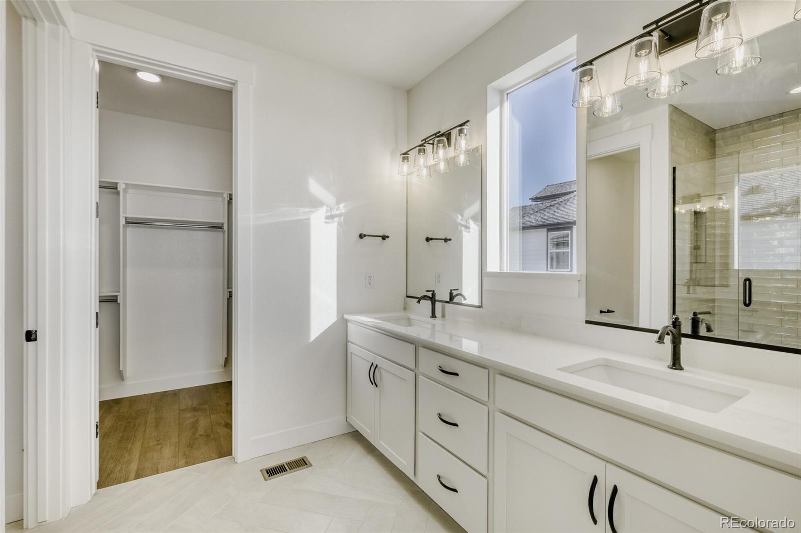 9659 Owl Perch Loop Colorado Springs, CO 80908 - Photo 22 of 28 a bathroom with a double vanity sink mirror and double