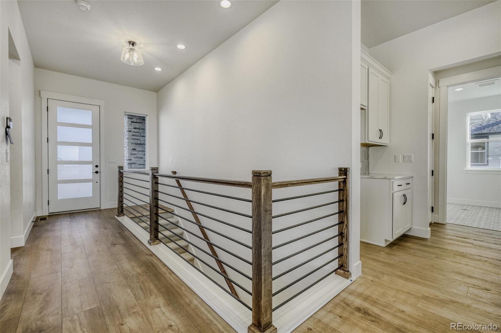 9659 Owl Perch Loop Colorado Springs, CO 80908 - Photo 4 of 28 a view of a hallway with closet and stairs