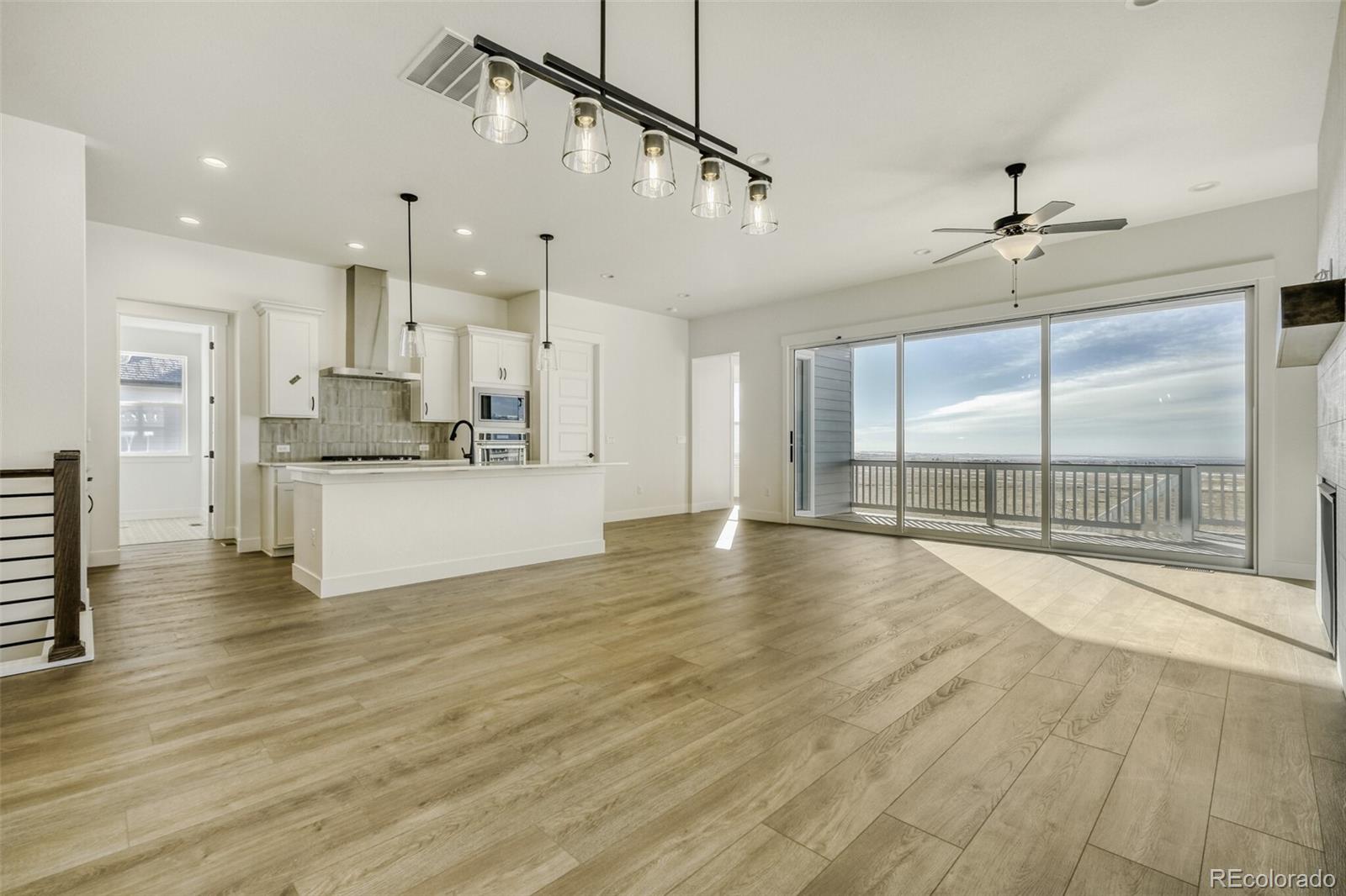 9659 Owl Perch Loop Colorado Springs, CO 80908 - Photo 10 of 28 a view of a kitchen with kitchen island a sink stainless steel appliances and cabinets