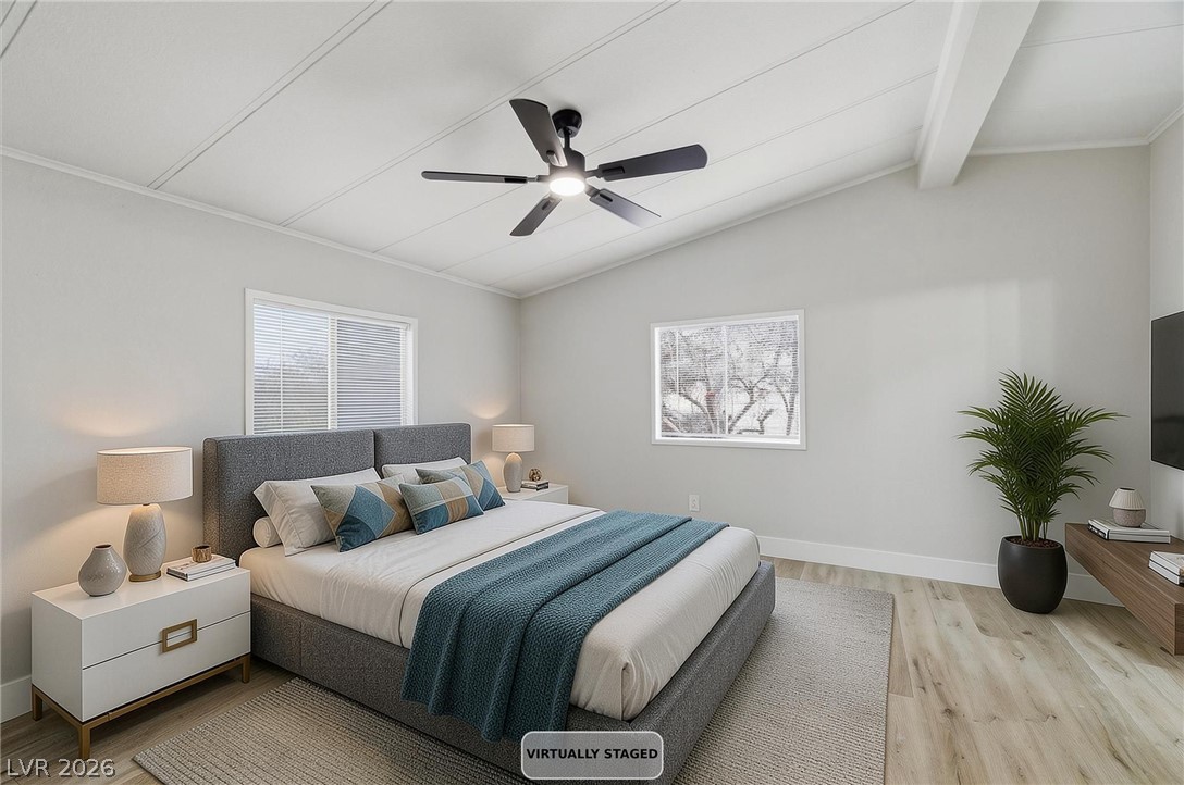 3940 Point Drive Pahrump, NV 89060 - Photo 20 of 35 Naturally illuminated bedroom with vaulted ceilings and wood plank flooring offers a serene retreat.