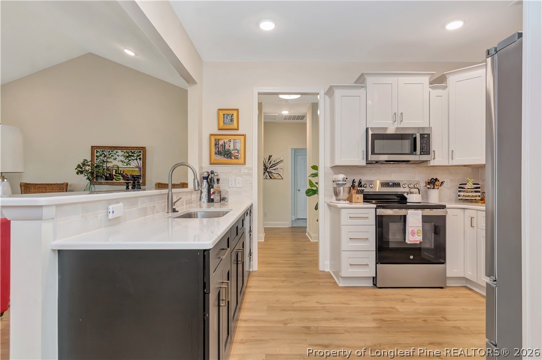 570 Old Tower Road Lumberton, NC 28360 - Photo 14 of 32 a kitchen with stainless steel appliances a stove sink microwave and cabinets