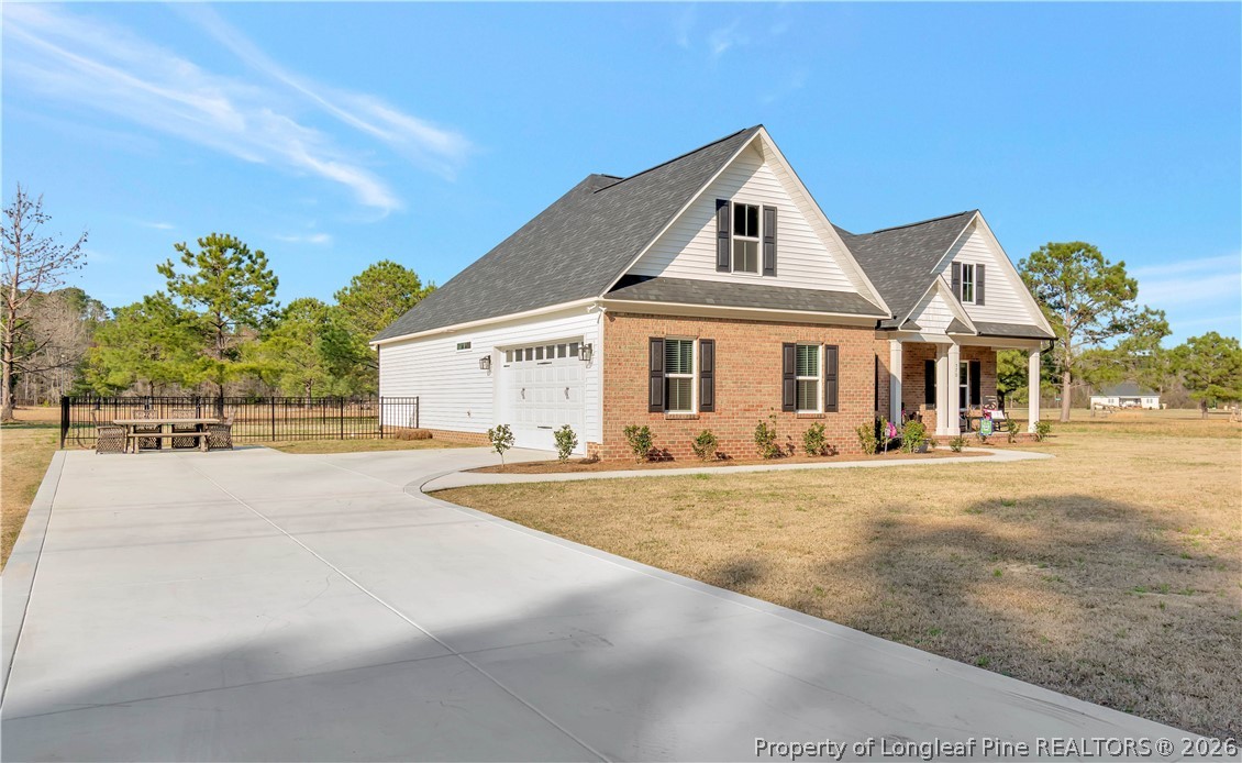 570 Old Tower Road Lumberton, NC 28360 - Photo 2 of 32 a front view of a house with a yard and garage