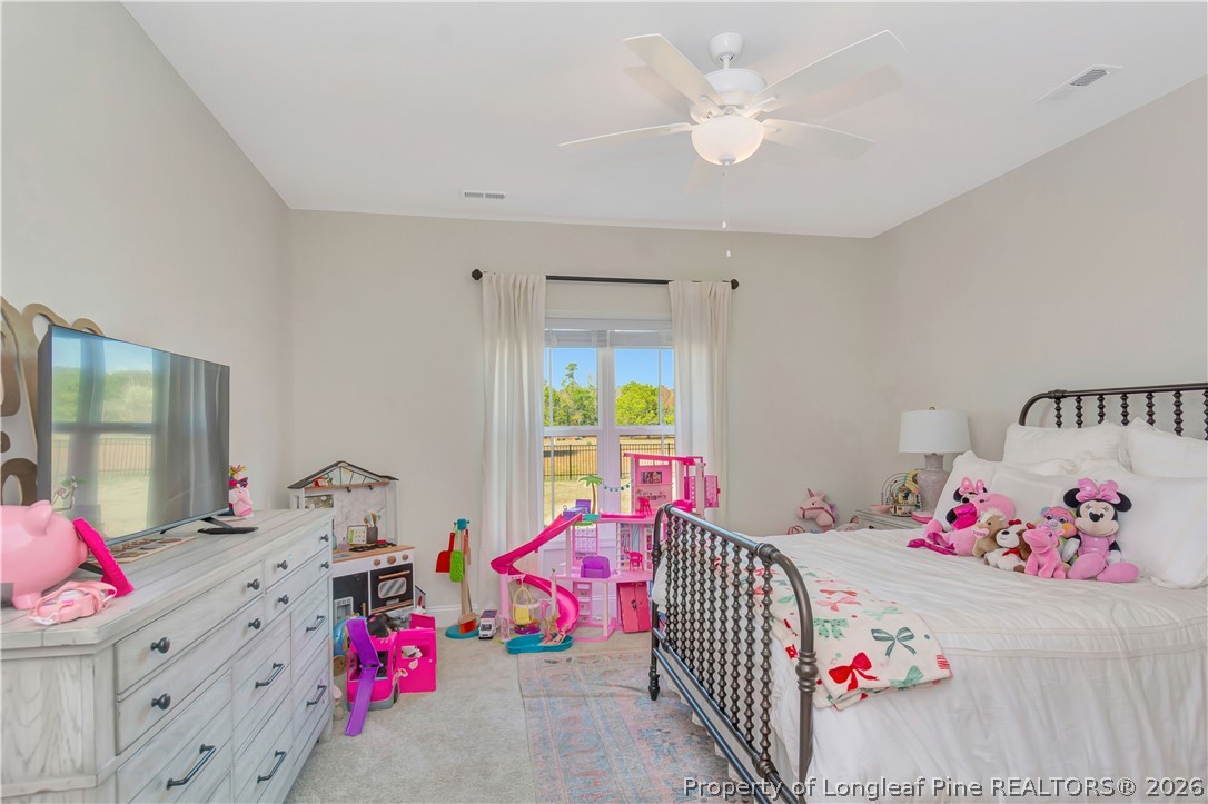 570 Old Tower Road Lumberton, NC 28360 - Photo 23 of 32 a bedroom with furniture and a chandelier