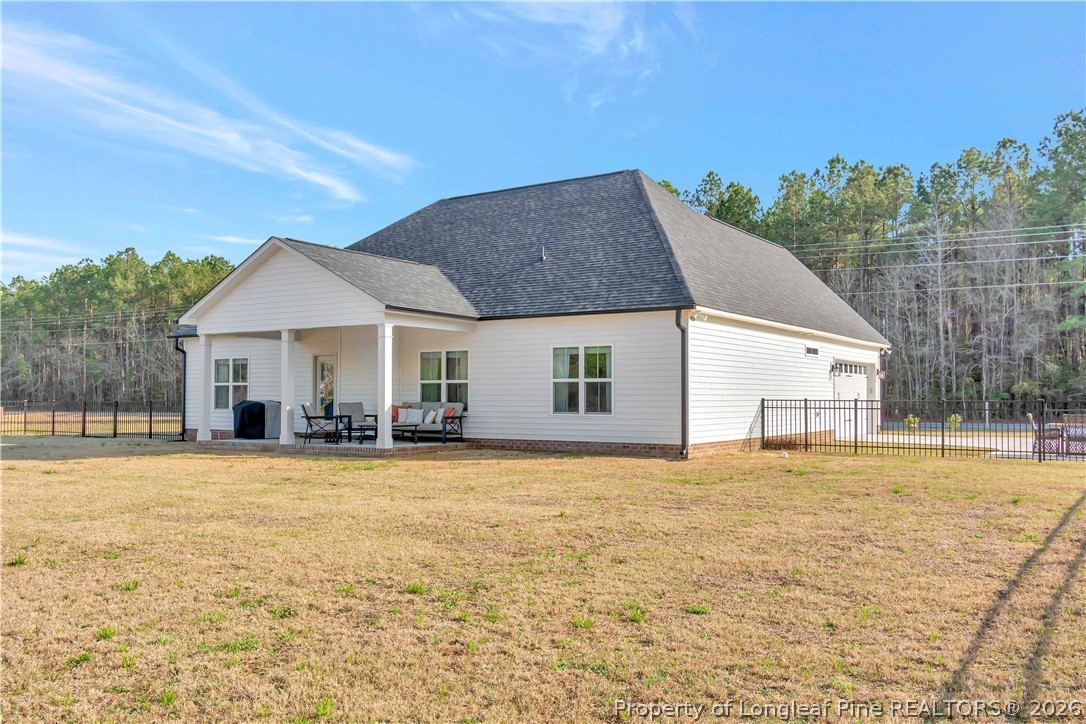570 Old Tower Road Lumberton, NC 28360 - Photo 31 of 32 a front view of a house with a garden and trees