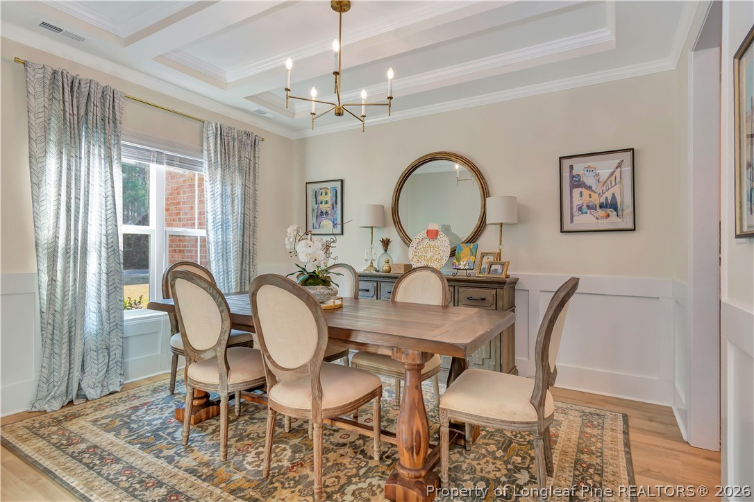 570 Old Tower Road Lumberton, NC 28360 - Photo 6 of 32 a dining room with furniture a chandelier and wooden floor