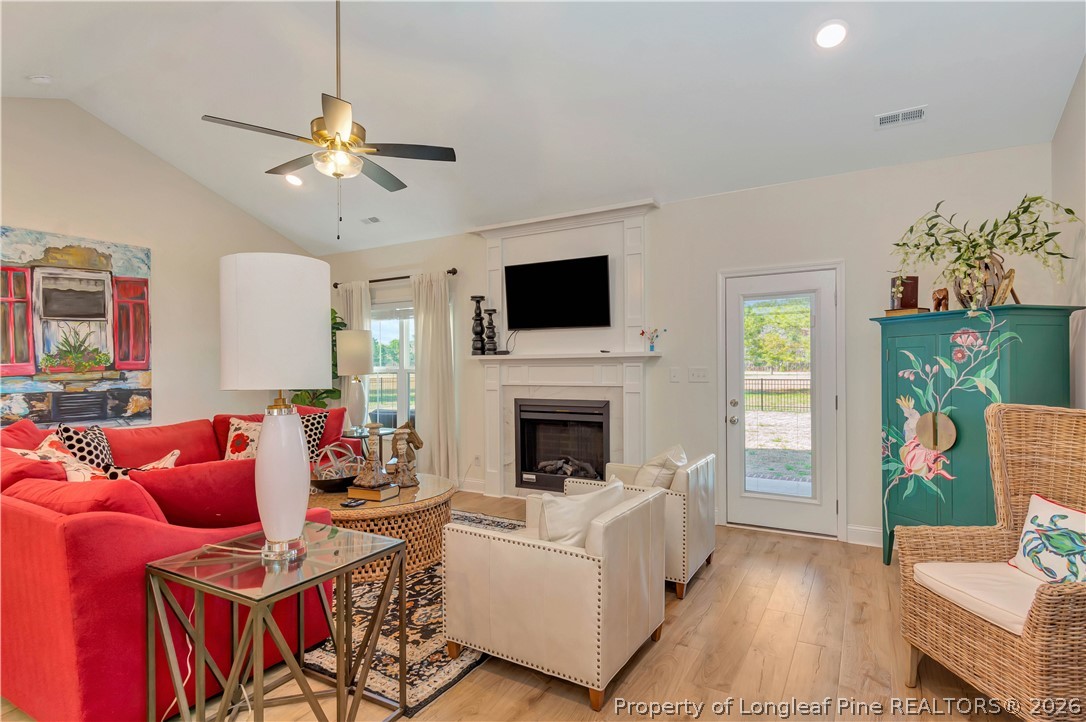 570 Old Tower Road Lumberton, NC 28360 - Photo 8 of 32 a living room with furniture a fireplace and a flat screen tv