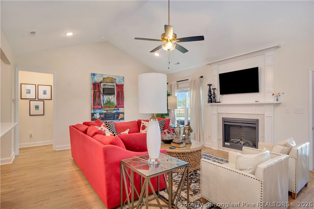 570 Old Tower Road Lumberton, NC 28360 - Photo 9 of 32 a living room with furniture a flat screen tv and a fireplace