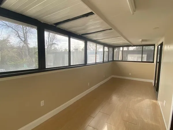 a view of empty room with large windows