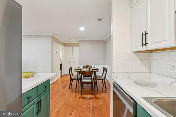 a kitchen with a sink and chairs