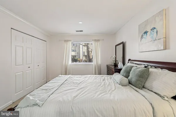 a bedroom with a large bed and a window