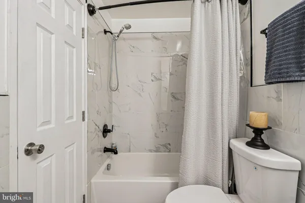 a bathroom with a toilet a sink and shower