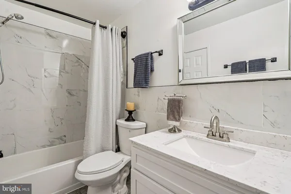 a bathroom with a sink toilet vanity and shower