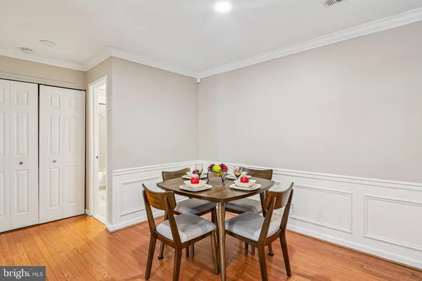 a view of a dining room with furniture and wooden floor