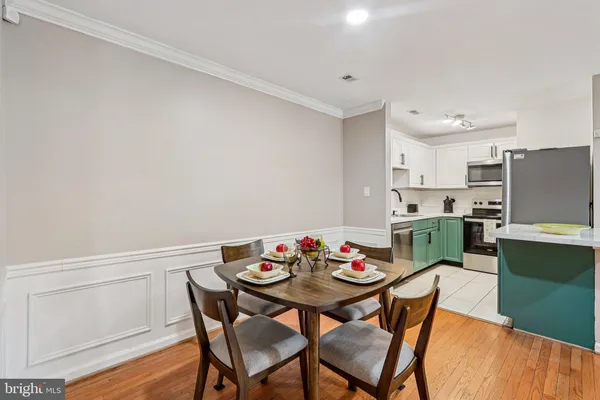 a view of a dining room with furniture and wooden floor