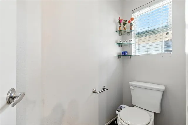 a white toilet sitting next to a window
