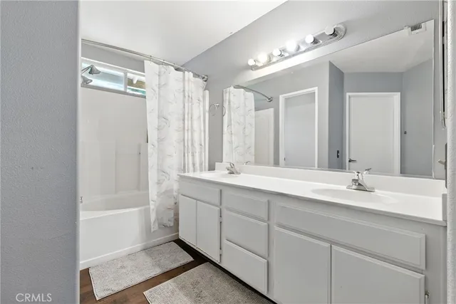 a bathroom with a double vanity sink mirror double and shower