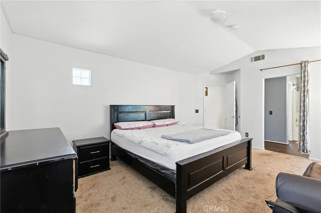 a bedroom with a bed and a desk