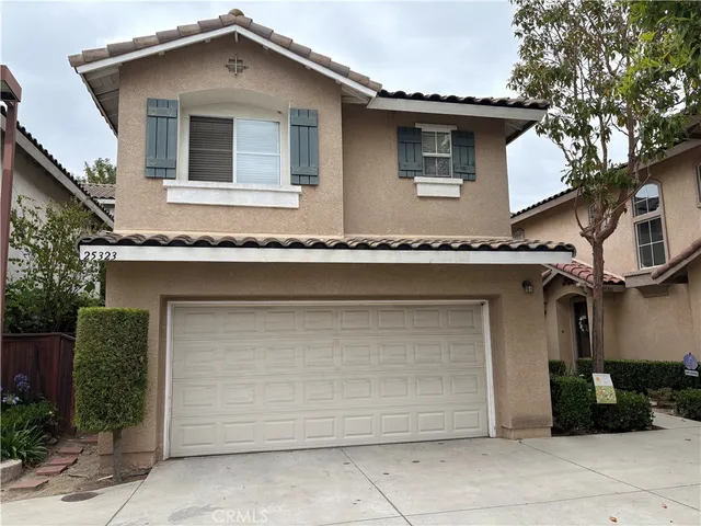 a front view of a house with garage
