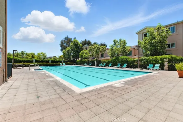 a view of a yard with plants and a barbeque