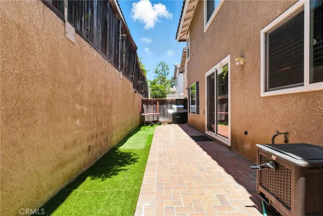 a view of a backyard with chair and wooden fence
