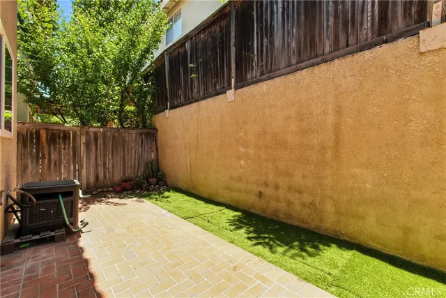 a view of a patio with a table and chairs