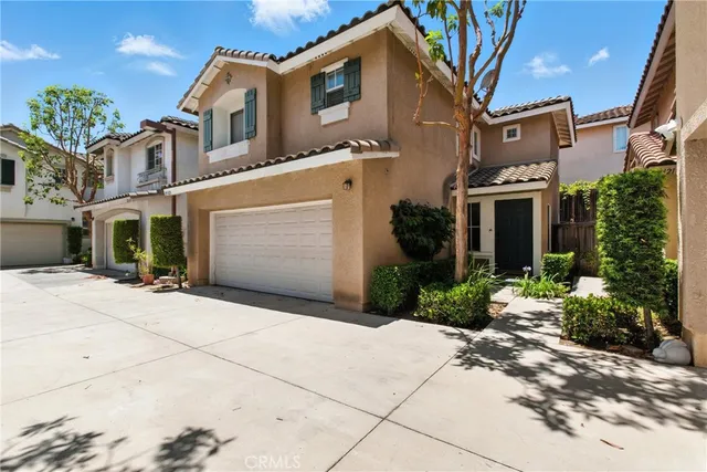 a front view of a house with a yard and a garage