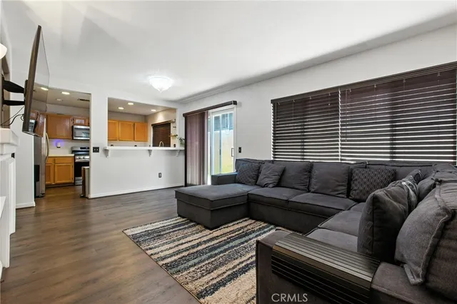 a living room with furniture and kitchen view