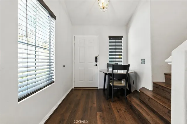 a view of a room with wooden floor and a window