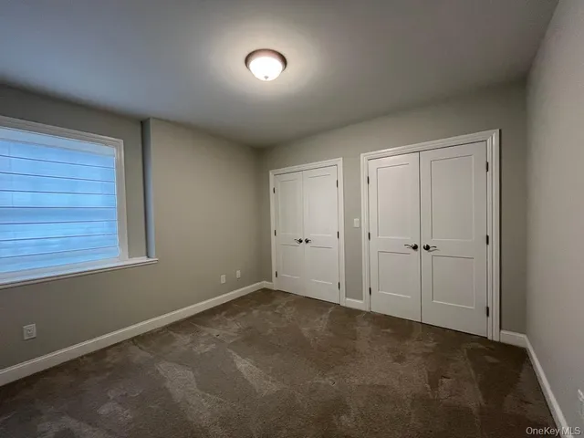 a view of an empty room and closet area