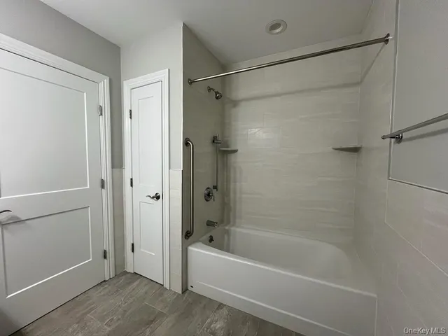 a bathroom with a bathtub and a shower