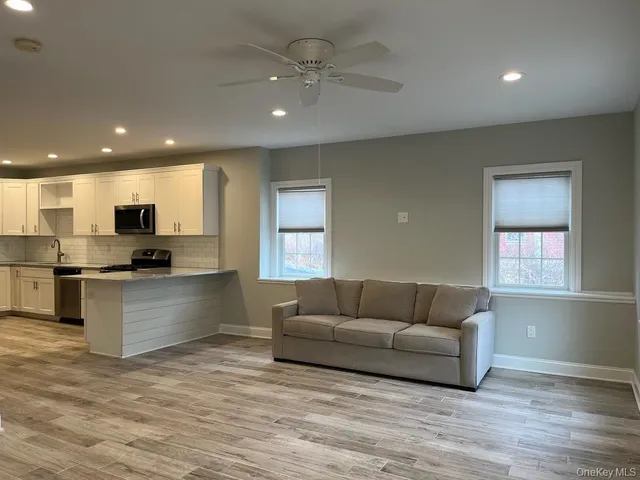 a living room with kitchen island furniture and a kitchen view