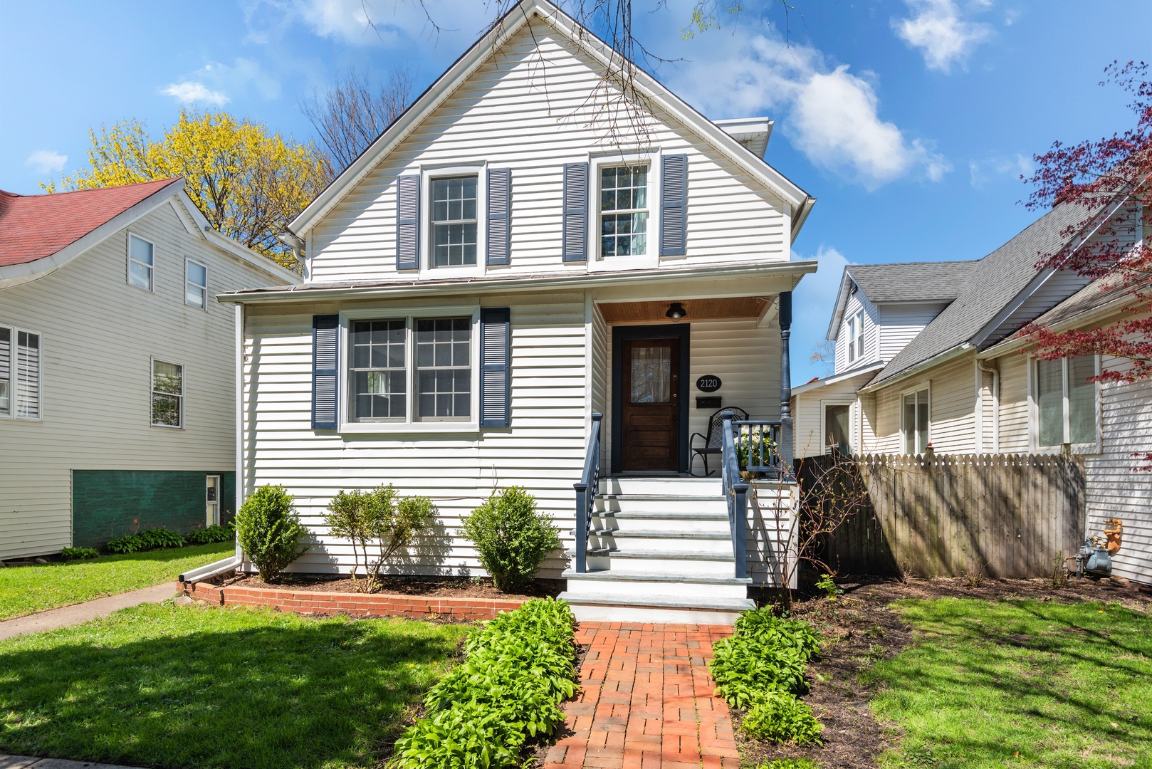 2120 Wesley Avenue Evanston, IL 60201 - Photo 1 of 32 a front view of a house with a yard and potted plants