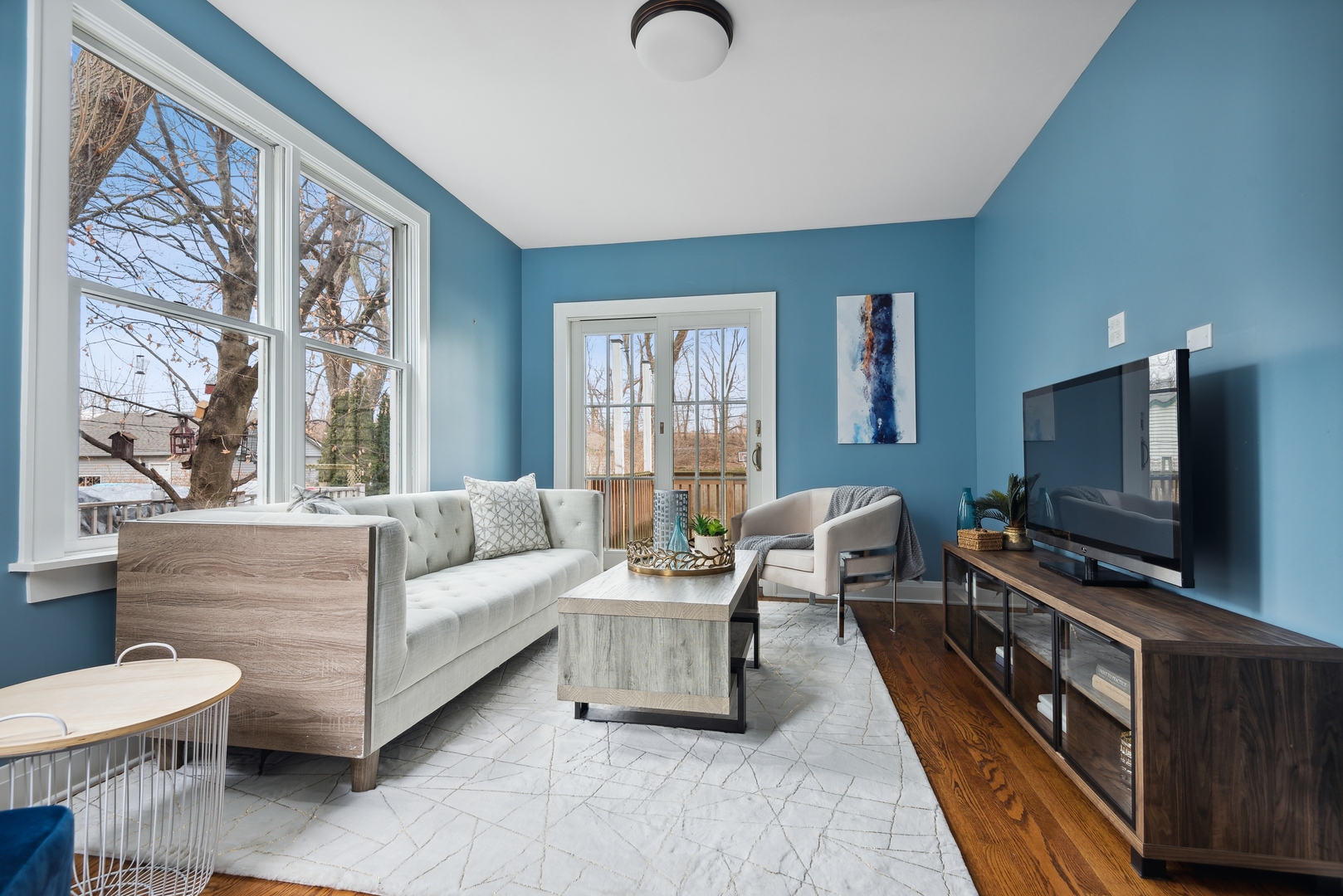 2120 Wesley Avenue Evanston, IL 60201 - Photo 13 of 32 a living room with furniture a flat screen tv and a large window
