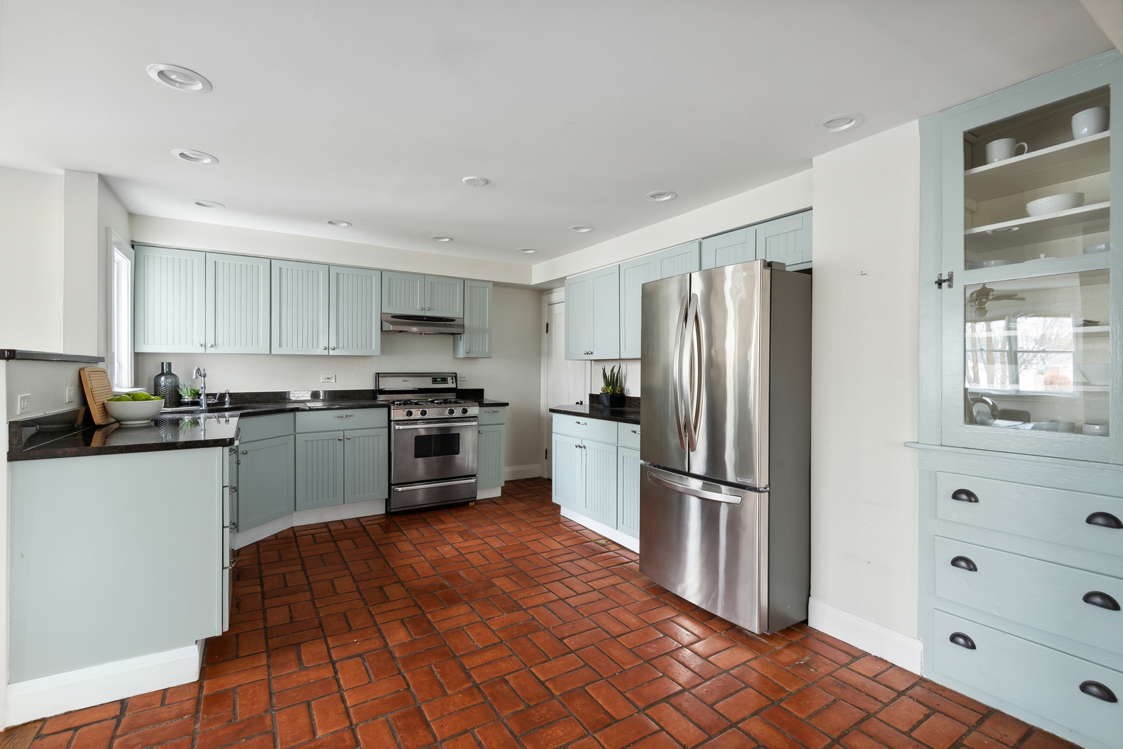 2120 Wesley Avenue Evanston, IL 60201 - Photo 8 of 32 a kitchen with granite countertop a refrigerator and a stove top oven