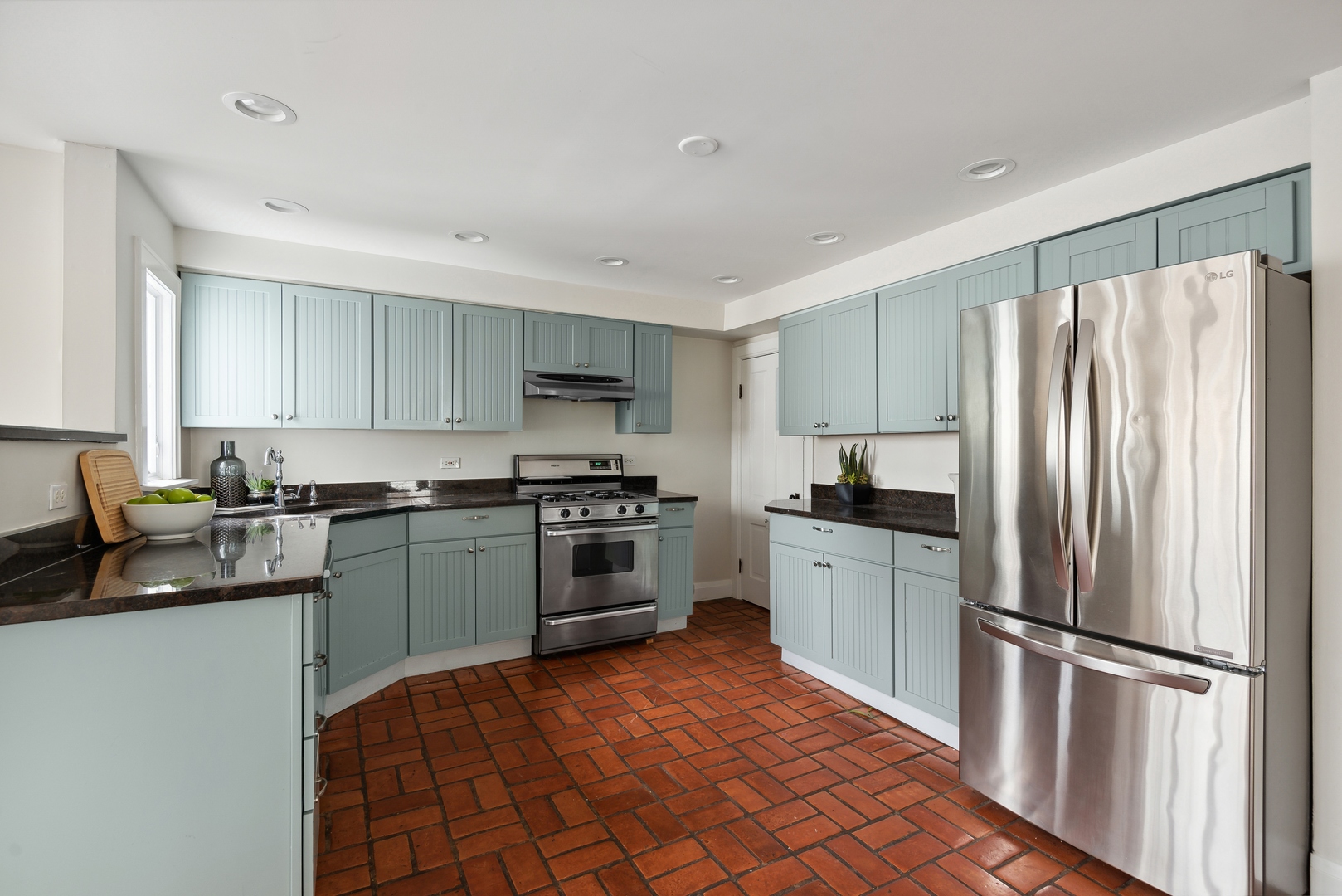 2120 Wesley Avenue Evanston, IL 60201 - Photo 9 of 32 a kitchen with stainless steel appliances granite countertop a refrigerator sink and stove