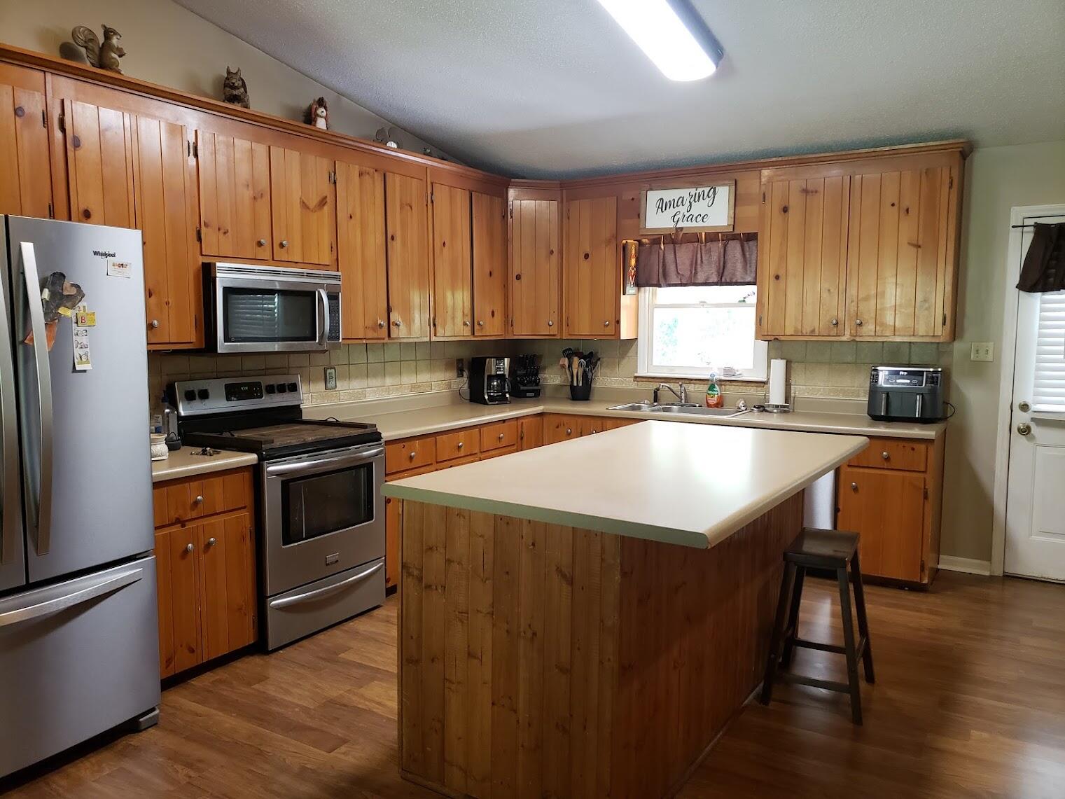 2040 Dugspur Road Callaway, VA 24067 - Photo 4 of 15 a kitchen with granite countertop a stove a sink dishwasher a refrigerator and a microwave