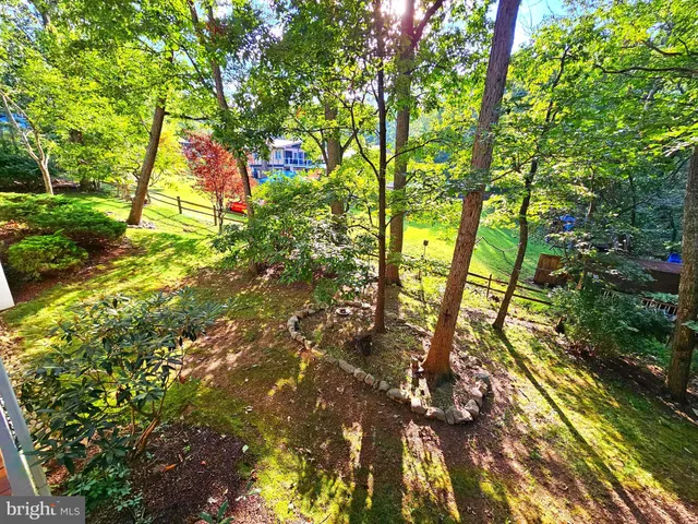 an empty room with windows and wooden floor