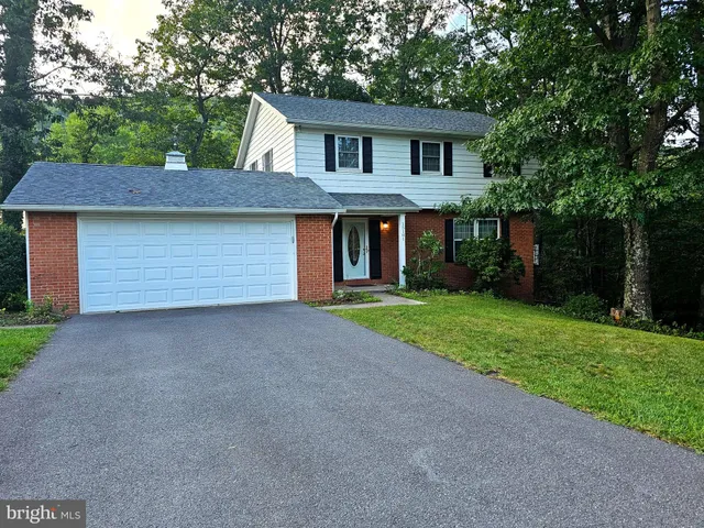 a front view of house with yard and trees