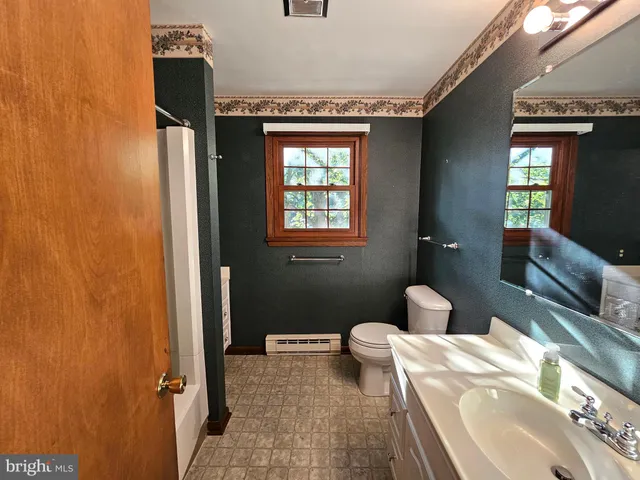 a bathroom with a toilet sink and shower