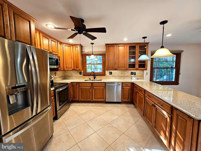 a kitchen with stainless steel appliances a sink window and refrigerator