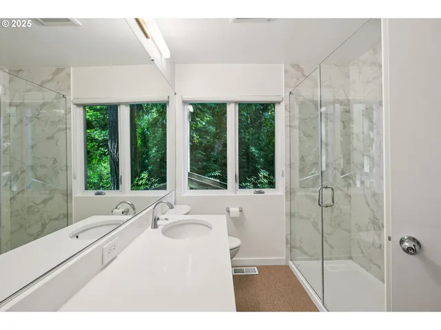 a bathroom with a granite countertop sink a large mirror and a bathtub