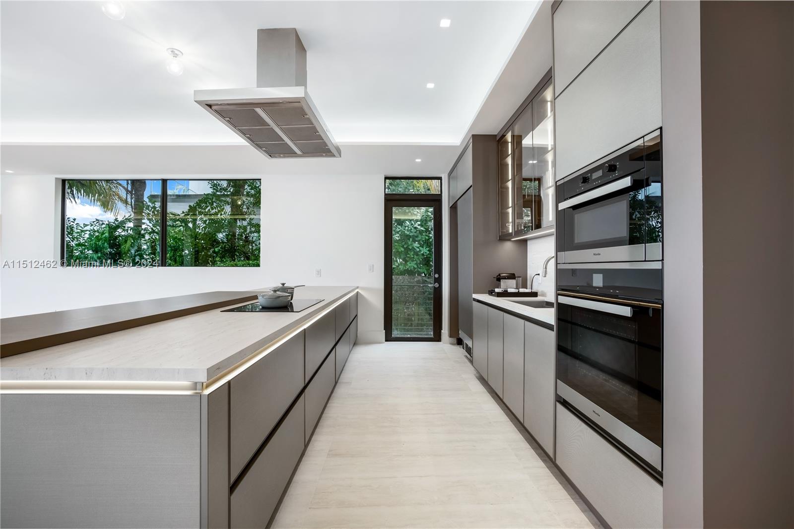 Normandy Shores Miami Beach, FL 33141 - Photo 32 of 47 a kitchen with stainless steel appliances a stove and more cabinets