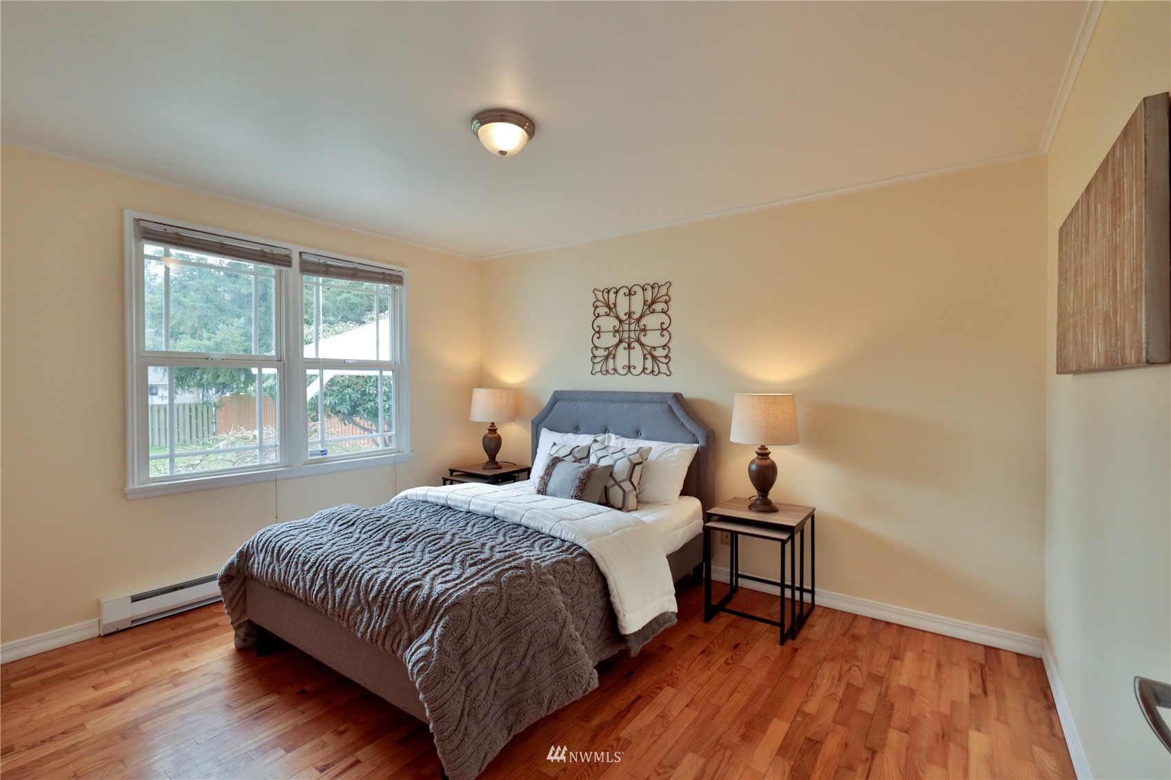 3129 Southeast 5th Street Renton, WA 98058 - Photo 11 of 27 a bedroom with a bed and wooden floor