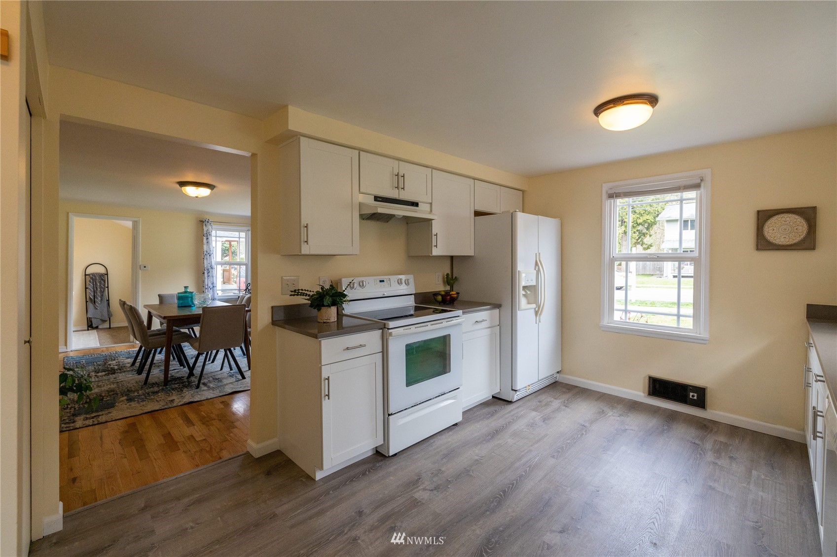 3129 Southeast 5th Street Renton, WA 98058 - Photo 7 of 27 a kitchen with a refrigerator and a stove top oven