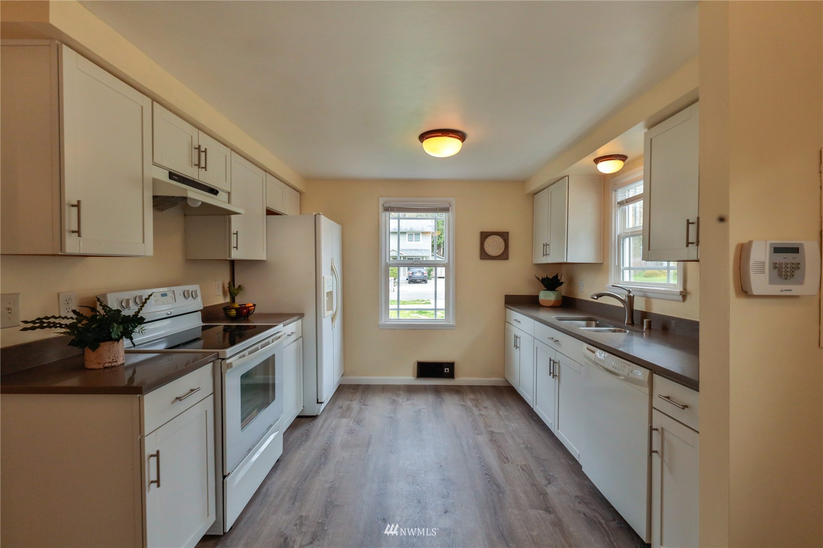 3129 Southeast 5th Street Renton, WA 98058 - Photo 10 of 27 a kitchen with stainless steel appliances granite countertop a stove a sink and a refrigerator
