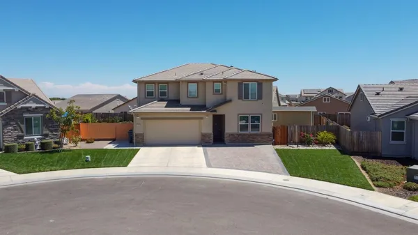 an aerial view of a house with garden space and street view