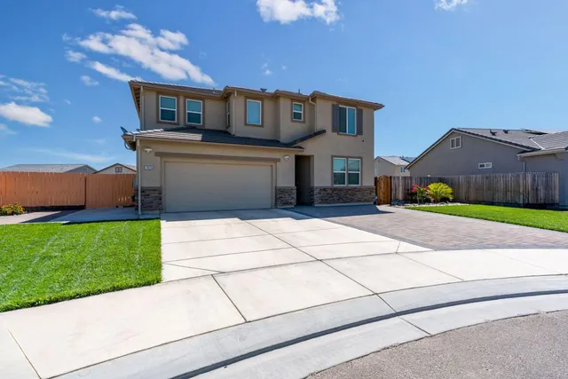 an aerial view of a house with garden space and street view