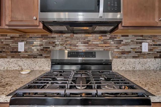 a living room with furniture a rug and a flat screen tv