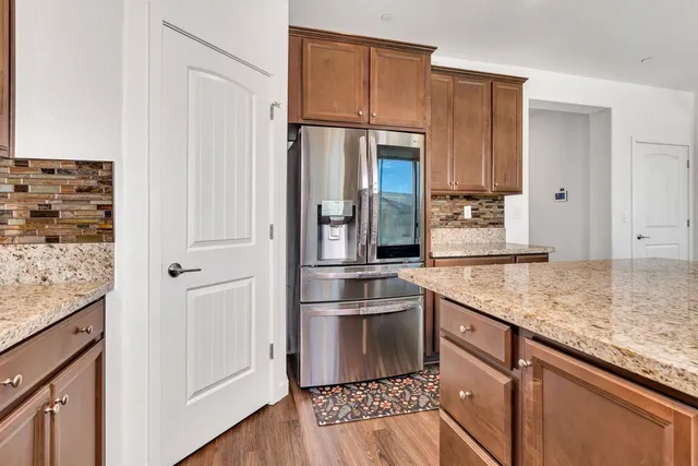 a living room with furniture a clock on wall and a window